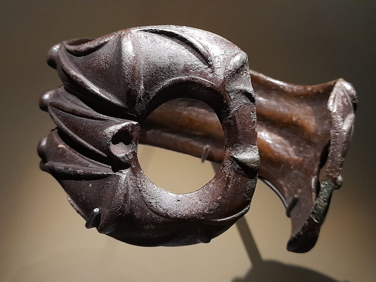 Native bronze armlet on display in the museum gallery.