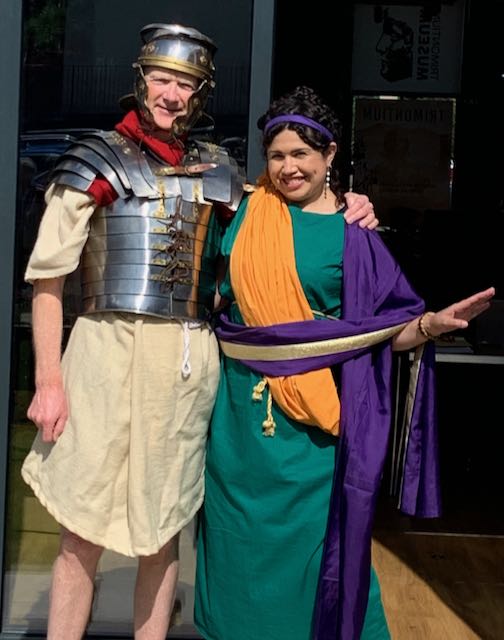 A man dressed as a Roman soldier with a woman wearing a Roman dress.