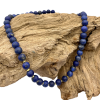lapis lazuli necklace on driftwood