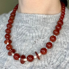 carnelian necklace over gray sweater