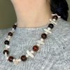 Fresh water pearl and agate necklace over gray sweater